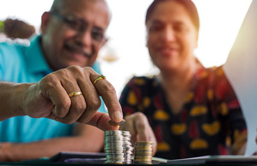 old couple with coin stack old couple with coin stack