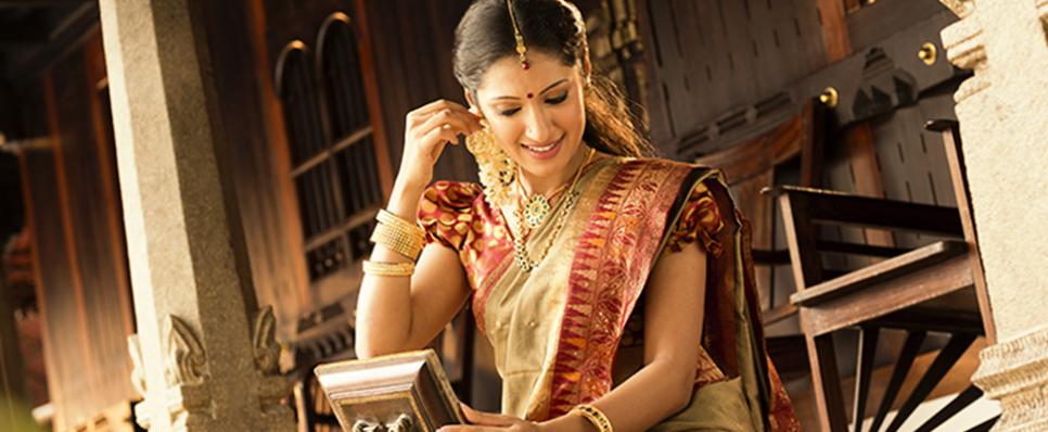 Woman wearing gold ornaments Woman wearing gold ornaments